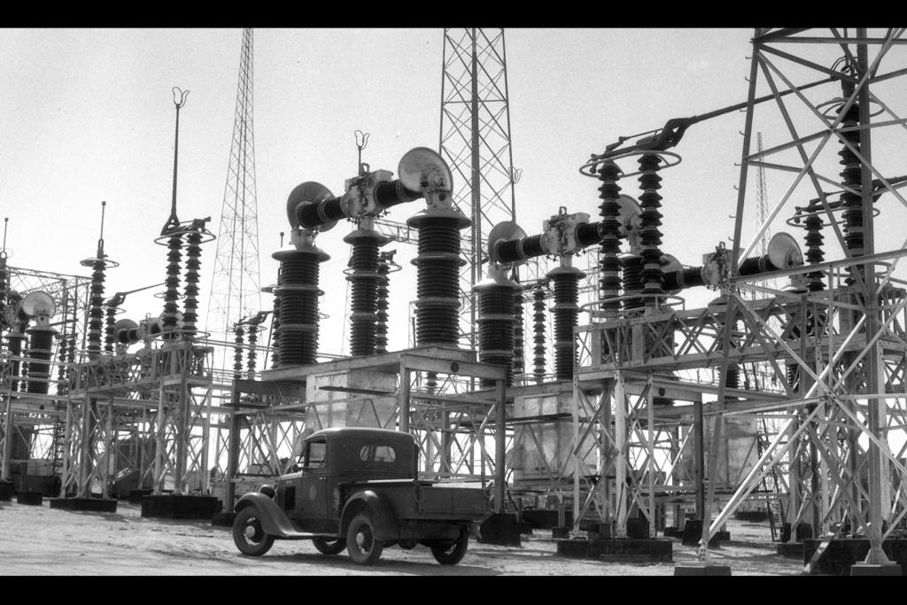 Pickup truck parked in front of power station