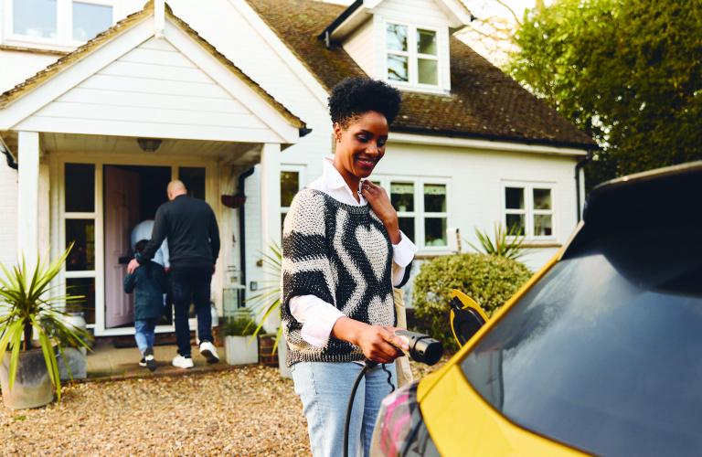 Woman plugging EV Car