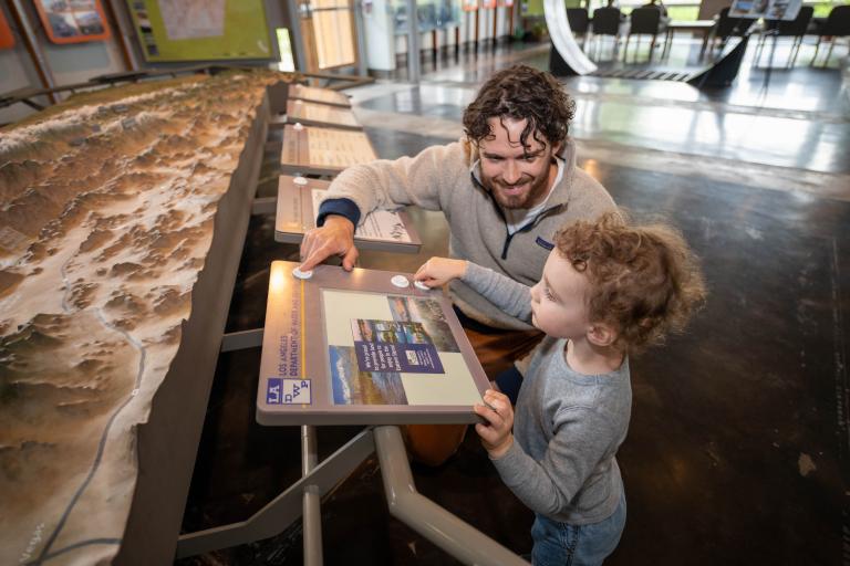 Community Partnerships Image for LADWP in the Eastern Sierra - Adult and child playing with exhibit