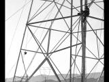 Workers constructing power transmission tower