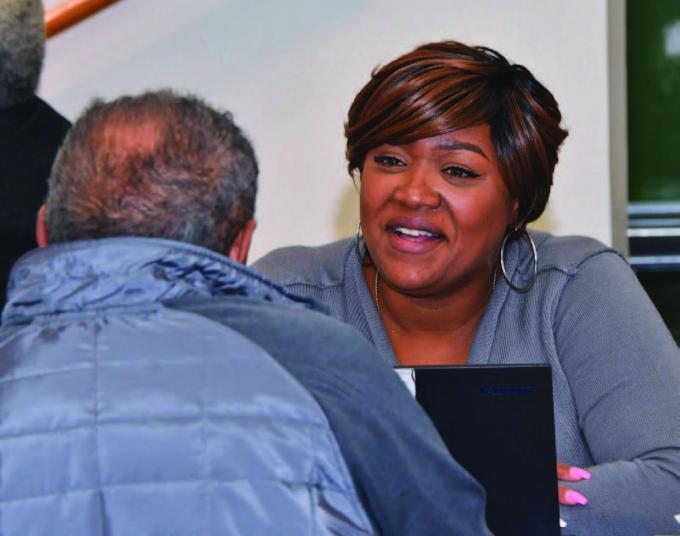 Women speaking with customer smiling