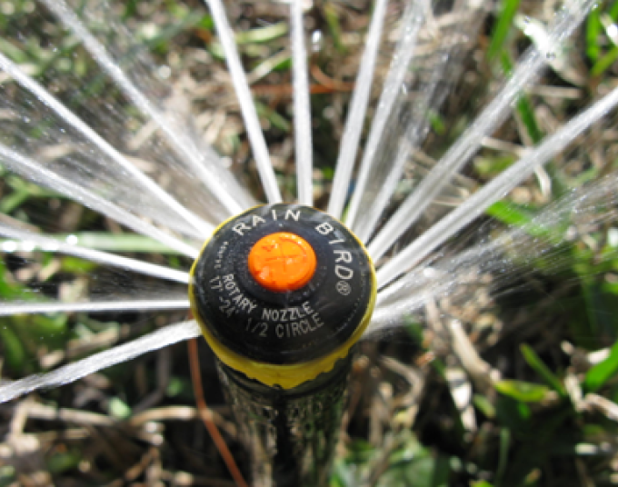 A sprinkler with a rotating nozzle head.