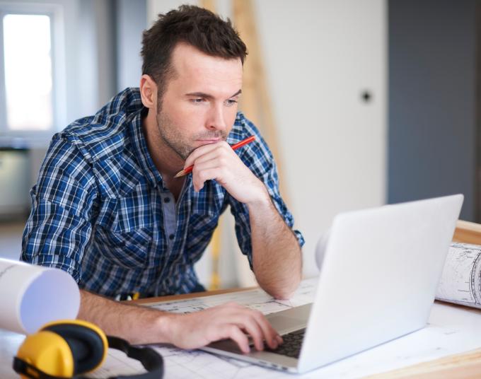 man sitting in front of laptop