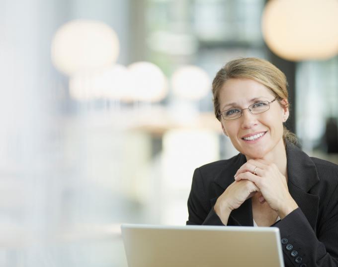 woman smiling in front of laptop