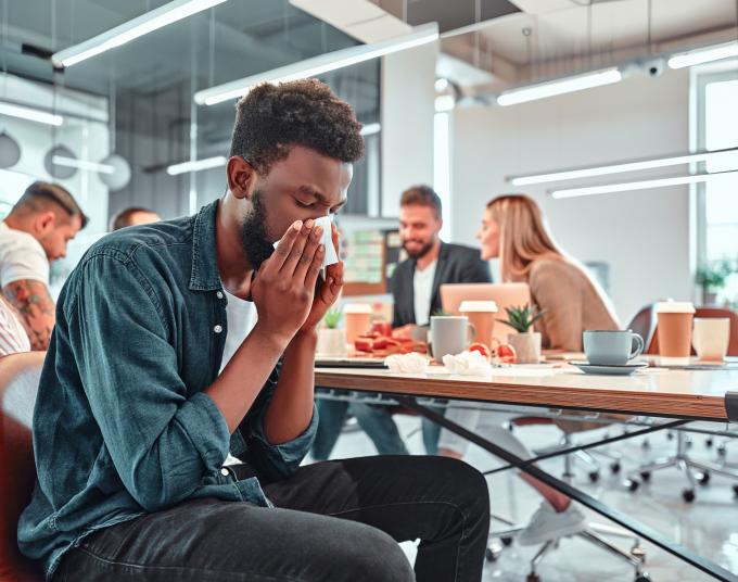 Person blowing nose with tissue