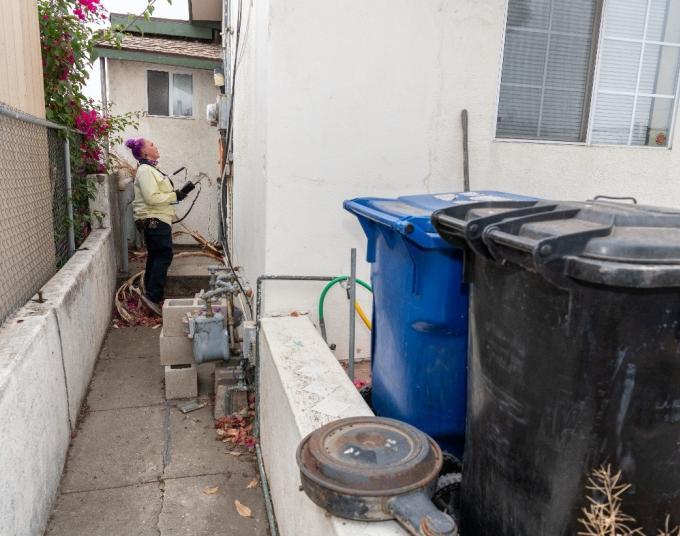 LADWP field employee looking at meter on house