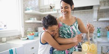 boy hugging woman - Refrigerator Recycling Program banner