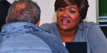 Women speaking with customer smiling