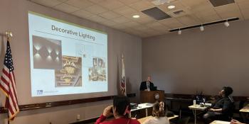 Workshop participants watch a presentation on lighting.