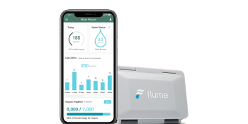 A Flume smart home water monitor device is positioned to the right of a smartphone showing the Flume app’s dashboard.