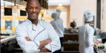 Man standing in restaurant kitchen
