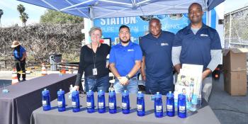 four ladwp employees in an LADWP booth at an event